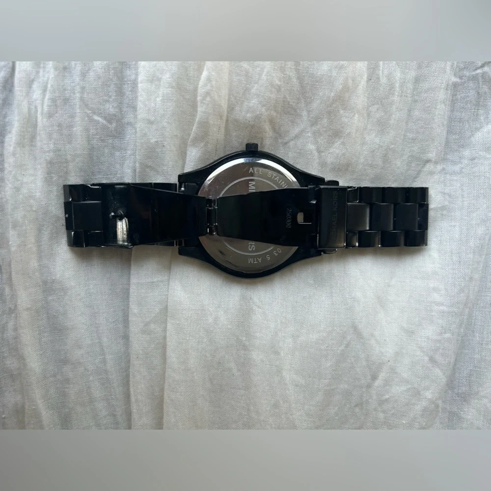 Michael Kors Black and Gold Watch It needs a battery replacement.
